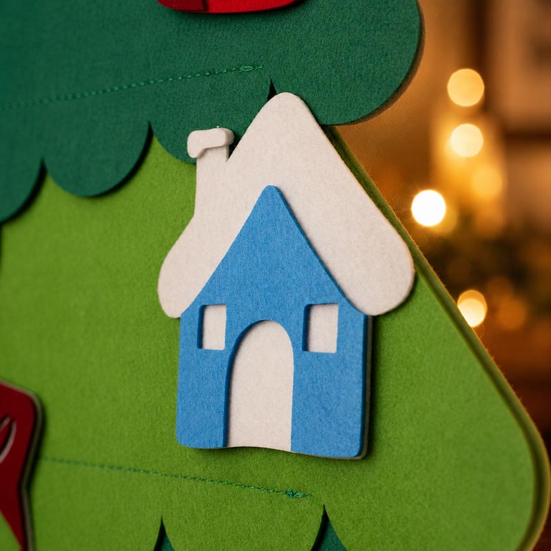 Close-up of a house-shaped felt ornament on the Christmas tree